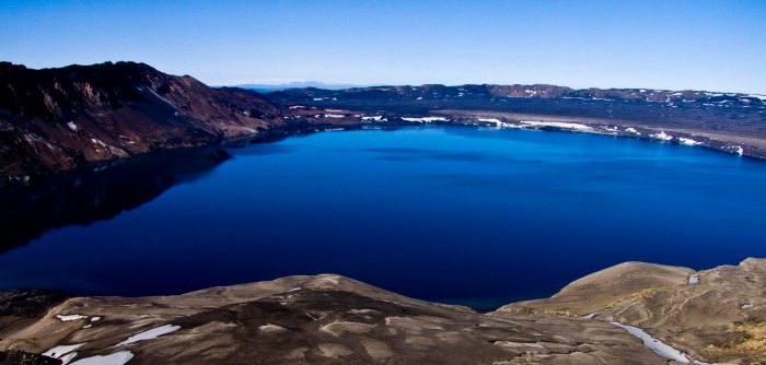 The dark blue beauty of Lake Öskjuvatn with the surrounding outer caldera wall clearly visible. Click on image to see it clearly. Image by unknown.